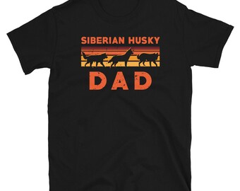 May include: Black t-shirt with a retro design featuring a silhouette of three Siberian Huskies and the text "Siberian Husky Dad".