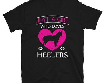 May include: Black t-shirt with a pink heart and a silhouette of a dog inside. The text "Just a girl who loves Heelers" is printed on the shirt.