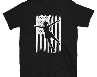 May include: Black t-shirt with a white silhouette of a figure ice skating in front of an American flag.