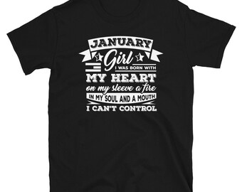 May include: Black t-shirt with white text that reads "JANUARY Girl I WAS BORN WITH MY HEART on my sleeve a fire IN MY SOUL AND A MOUTH I CAN'T CONTROL"