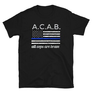May include: Black t-shirt with a blue and white American flag with a blue line across the middle. The text "A.C.A.B. all cops are brave" is printed below the flag.