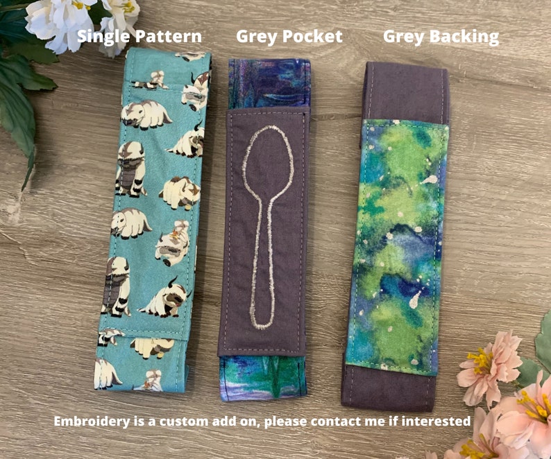 May include: Three fabric spoon holders with different patterns. The first is a light blue fabric with a white pattern of cartoon animals. The second is a dark grey fabric with a white embroidered spoon design. The third is a green and blue fabric with a white watercolour pattern. The text "Single Pattern", "Grey Pocket", and "Grey Backing" is above each holder.