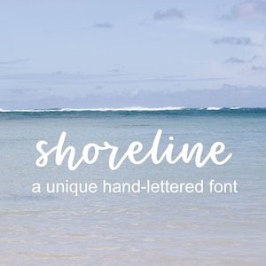 May include: A white hand-lettered font called "shoreline" is displayed against a backdrop of a blue ocean and a light blue sky with white clouds. The text reads "shoreline" and "a unique hand-lettered font".