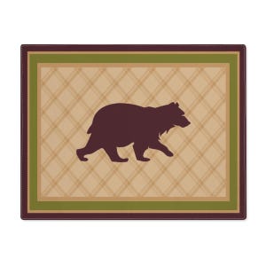 May include: A brown bear silhouette on a tan and green plaid background. The bear is walking to the right. The background has a brown leather border.