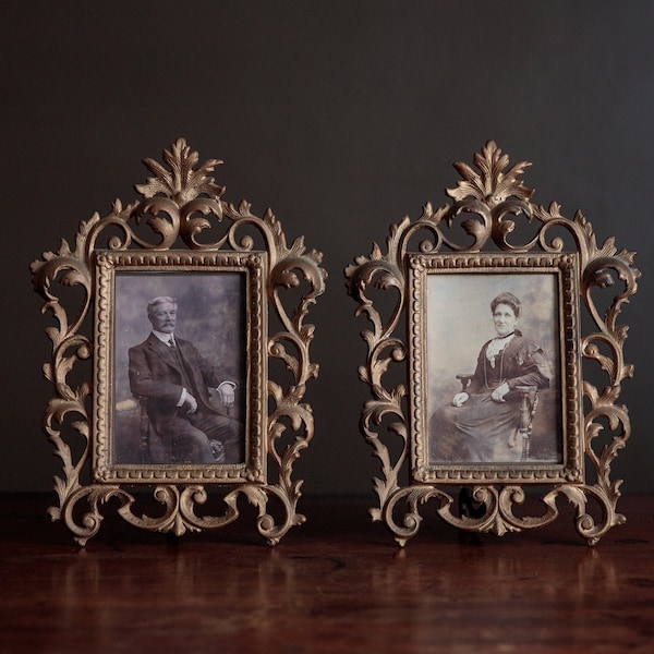 Pair of antique frames with black and white photographs of a Victorian couple