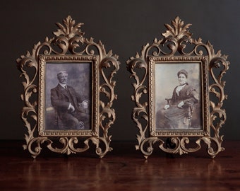 Pair of antique frames with black and white photographs of a Victorian couple