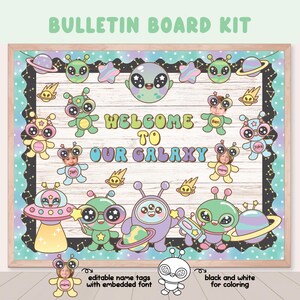 May include: A wooden bulletin board kit with a space theme. The board features cartoon aliens, planets, and stars, with the text "WELCOME TO OUR GALAXY." Includes editable name tags and a black and white coloring option.