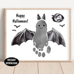May include: A framed print with a bat design made from a footprint, with the text "Happy Halloween!". The bat has wings and a smiling face. Additional bat silhouettes and a moon graphic are also included. The words "Instant Download" are in a black circle.
