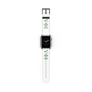 May include: White Apple Watch band with green Greek letters. The band features the Greek letters "VΦI" in green on a white background. The watch face is black with white hands.