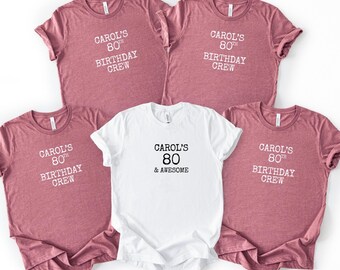 May include: Five t-shirts, four in a dusty rose color and one in white. The shirts have the text "CAROL'S 80TH BIRTHDAY CREW" and "CAROL'S 80 & AWESOME" printed on them in white and black.