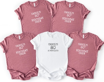 May include: Five t-shirts, four in a mauve color and one in white. The mauve shirts read "Carol's 80th Birthday Crew" in white text. The white shirt says "Carol's 80 & Fabulous" in black text.