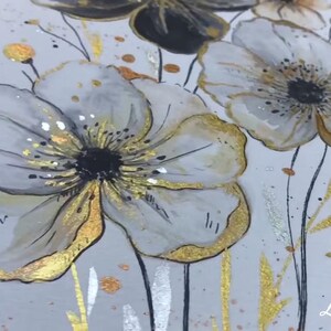 May include: A watercolor painting of white flowers with gold accents on a white background. The flowers have black centers and are surrounded by gold and silver glitter.