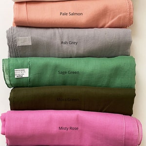 May include: A stack of ten fabric swatches in various colors, including sandy beige, snow white, pale salmon, ash grey, sage green, moss green, misty rose, dusky lavender, and celestial blue.