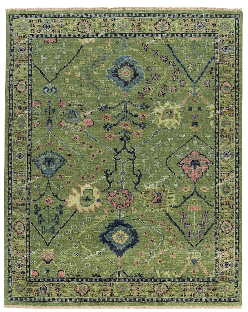 May include: A green rug with a traditional Persian design. The rug features intricate floral patterns in shades of pink, blue, and yellow.