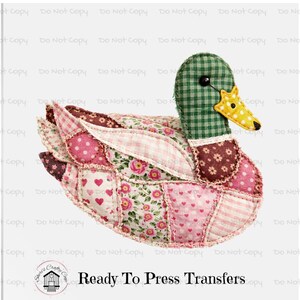 May include: A handcrafted duck-shaped appliqué with a patchwork design. The duck features a green and white checkered head, a yellow beak, and wings and body made of various pink and floral patterned fabrics. The text "Ready To Press Transfers" is visible.