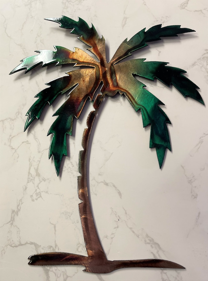 May include: A metal palm tree wall art with a green and brown color scheme. The palm tree is made of metal and has a rustic look.