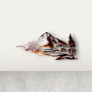 May include: Metal wall art depicting a mountain range with trees. The art is made of copper and has a rustic, natural look.