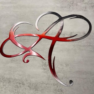 May include: A red and black metal letter A with a decorative, stylized design. The letter is made of metal and has a shiny finish.