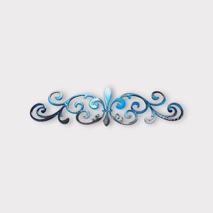 May include: A blue and silver decorative metal scroll design with a flourish in the center.