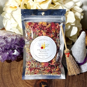 May include: A small pouch containing a blend of dried herbs and rose petals. The pouch is labeled "Practical Magic" and "Mini Simmer Pot Herb/Burn Pack 5 oz".