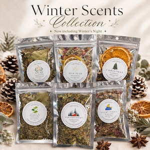 May include: Six clear resealable pouches containing dried herbs, spices, and fruit slices, labeled Winter Scents Collection. Each 5 oz pack features a circular white label with names like Yule, New Year, Christmas, Success & Abundance, Winter's Night, and Silent Night.