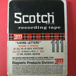 May include: Vintage Scotch brand recording tape cassette. The black and white label features the brand name, product details, and the text "LIVING LETTERS". The reel holds 150 feet of tape and is marked with the number 111.