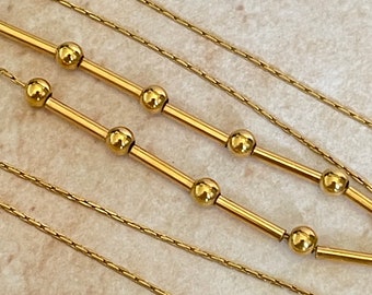 Chain decorated with rods and beads in 18k yellow gold, length 43 cm