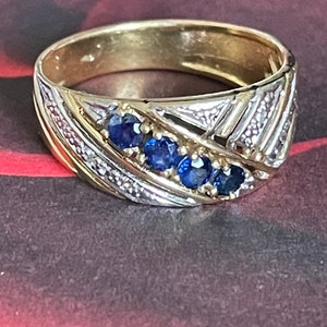 18k yellow gold ring with 4 sapphires surrounded by 6 diamonds