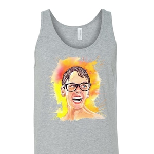May include: A gray tank top with a watercolor illustration of a person wearing glasses and smiling. The illustration is surrounded by yellow and orange paint splatters.
