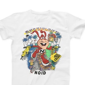 May include: White t-shirt with a cartoon character called the Noid. The Noid is red and has a large nose and is skateboarding. The text "Bustin' Out" is above the Noid and the text "Noid" is below the Noid.
