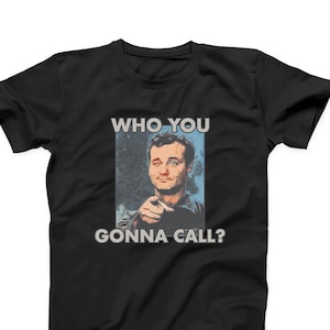 May include: Black t-shirt with a graphic of Bill Murray from the movie Groundhog Day. The graphic features a close-up of Bill Murray's face with the text "Who you gonna call?" printed below.