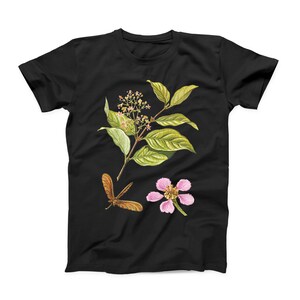 May include: Black t-shirt with a floral design featuring pink flowers, green leaves, and a brown dragonfly.