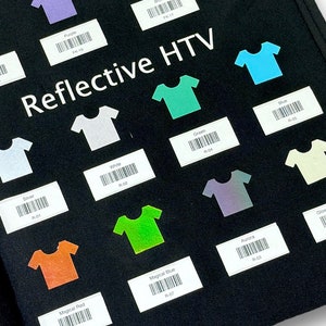 May include: A black fabric swatch book with color samples of heat transfer vinyl (HTV) in various colors, including purple, teal, orange, green, white, silver, and glow-in-the-dark. The book is labeled "Flock HTV" and "Reflective HTV".
