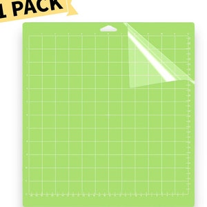 May include: A green self-healing cutting mat with a grid pattern and a clear protective sheet. The mat has measurements in inches along the edges.  The mat is labeled "1 PACK".