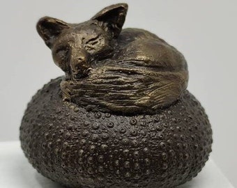 Sleeping fox on sea urchin, cast bronze