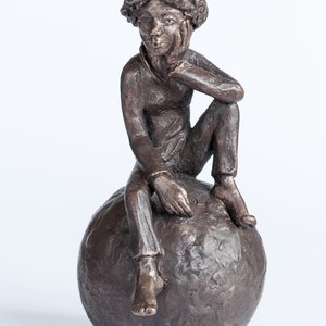 Whistling on ball, bronze sculpture image 1