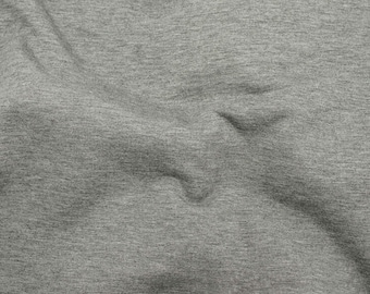 May include: Close-up of a gray, textured fabric with a subtle wave pattern. The fabric has a soft, slightly wrinkled appearance.