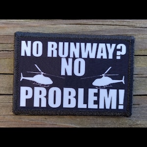 May include: Black patch with white text and helicopter silhouettes. The text reads "NO RUNWAY? NO PROBLEM!"