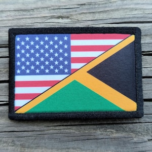 May include: Rectangular patch featuring the American and Jamaican flags. The American flag is on the left, with red and white stripes and a blue field of white stars. The Jamaican flag is on the right, with a black triangle, yellow diagonal, and green triangle.