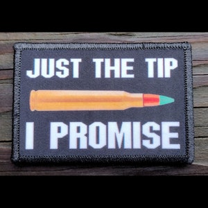 May include: Black rectangular patch with the text "JUST THE TIP I PROMISE" in white. The patch features an orange bullet with a red and green tip.