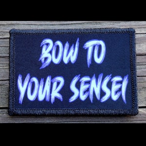 May include: Black patch with white stitching around the edges. The patch has the text "BOW TO YOUR SENSEI" in a purple, brushstroke font.