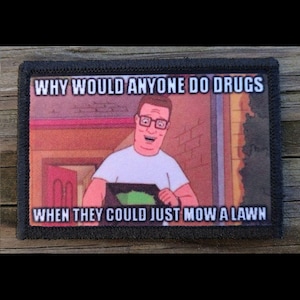 May include: A rectangular patch with a black border featuring a cartoon image of a man in glasses. The text reads "WHY WOULD ANYONE DO DRUGS WHEN THEY COULD JUST MOW A LAWN". The image has a background of a house.