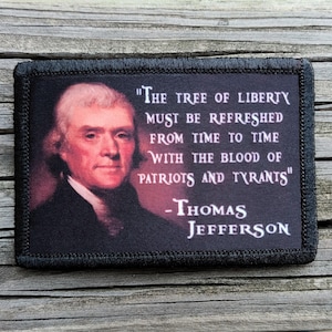 May include: A rectangular patch with a portrait of Thomas Jefferson and a quote. The quote reads "The tree of liberty must be refreshed from time to time with the blood of patriots and tyrants." The patch has a black border.