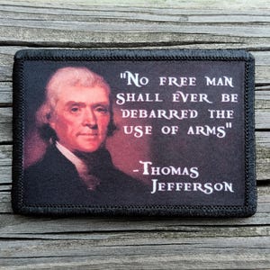 May include: A rectangular patch with a portrait of Thomas Jefferson and a quote. The quote reads "No free man shall ever be debarred the use of arms" and is attributed to Thomas Jefferson. The patch has a black border.