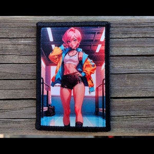 May include: A rectangular patch featuring an anime-style illustration of a person in athletic wear. The person has pink hair, a white crop top, black shorts, and a blue and orange jacket. The background shows a gym setting.