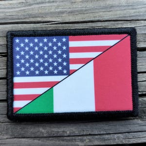 May include: Rectangular patch featuring a split design of the American and Italian flags. The American side displays the stars and stripes, while the Italian side shows green, white, and red. The patch is bordered with black stitching.