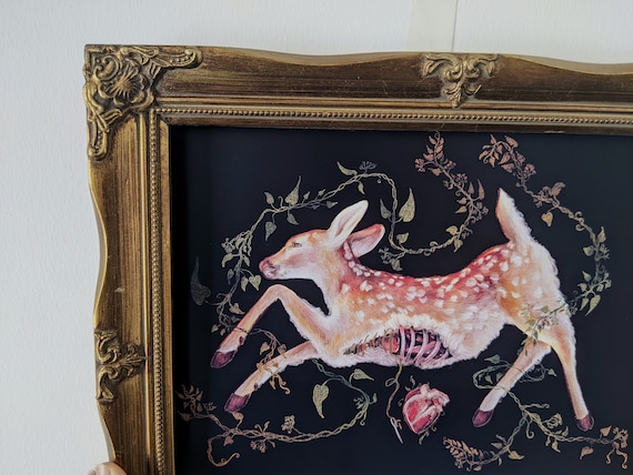 A hauntingly beautiful handmade art print blending gothic deer anatomy with florals — the kind of darkly poetic wall art that stops people mid-scroll.