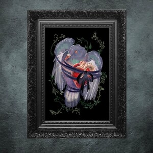 May include: A framed artwork featuring a watercolor illustration of a pigeon with its wings spread, wrapped with blue ribbons and a black bow. The pigeon holds a heart, surrounded by green vines, set against a black background within a black ornate frame.