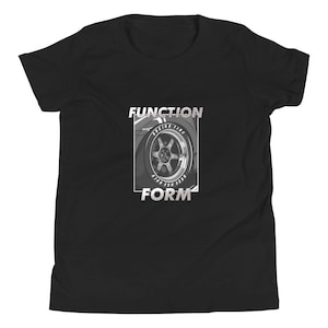May include: Black t-shirt featuring a grayscale graphic of a car wheel with the words "FUNCTION" and "FORM" in a white, outlined font. The wheel design includes the text "RACING TIRE".