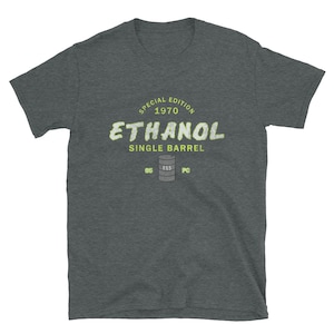 May include: Dark grey t-shirt featuring a light green graphic with the words "ETHANOL SINGLE BARREL 1970 SPECIAL EDITION" and a barrel illustration. Below the barrel are the letters "85 E85 PC".